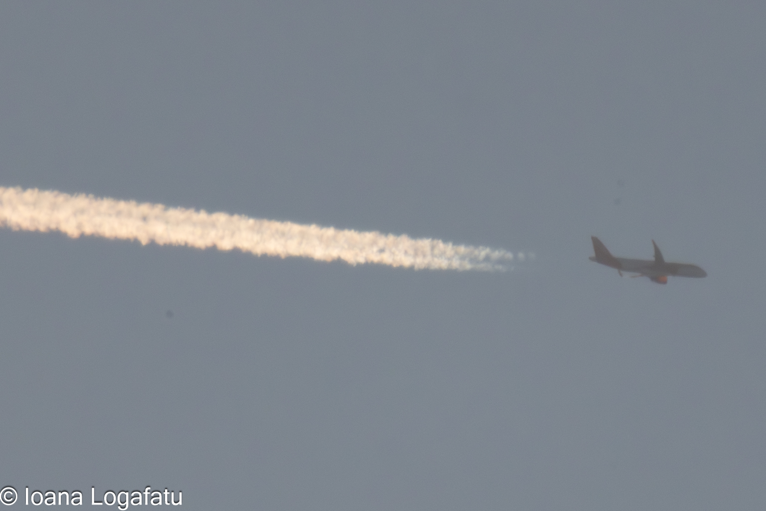 Flying high with trails across the afternoon sky